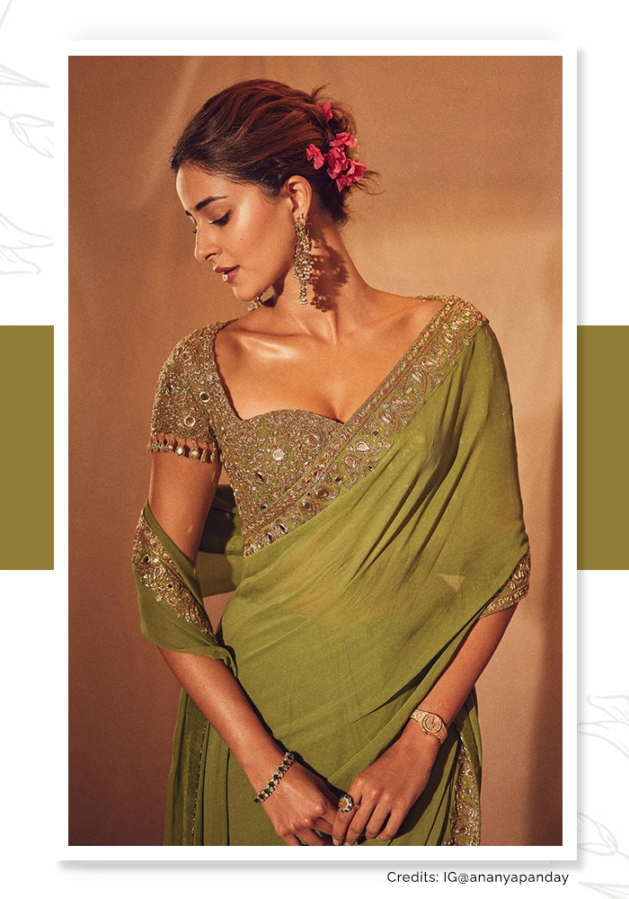 Ananya Panday wearing a green georgette saree and red flowers on her bun