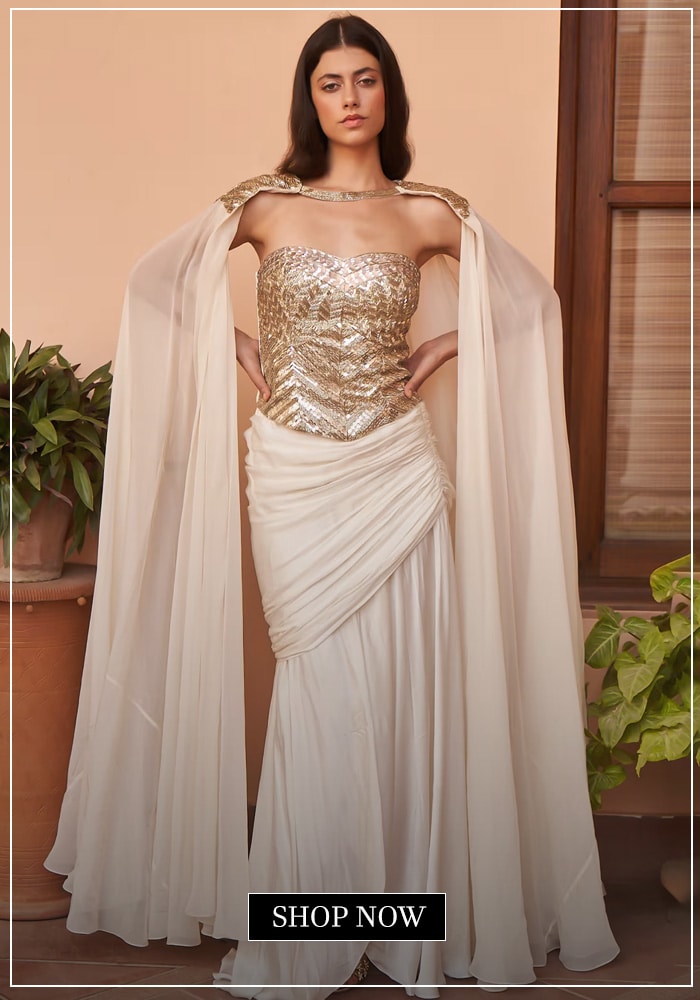 White cape, gold corset and white draped skurt set