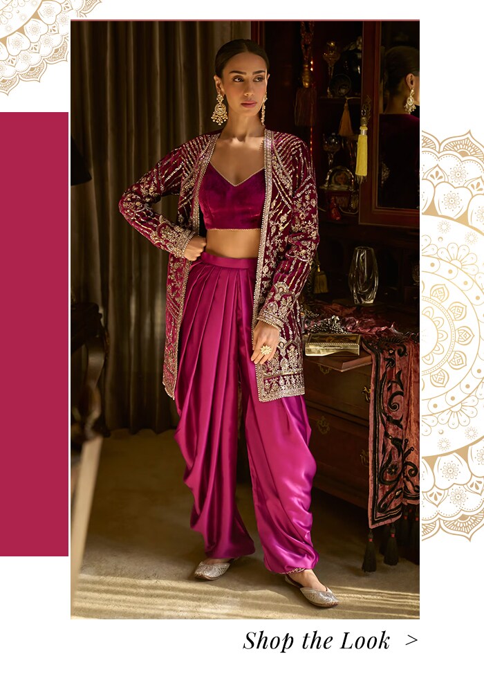 Model wearing a embroidered magenta jacket and draped pant set
