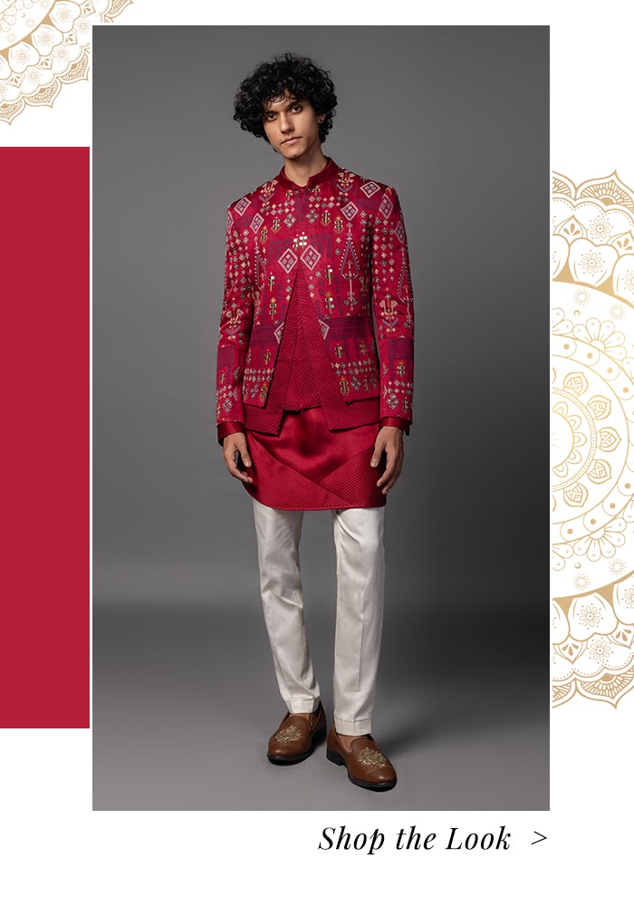 Model wearing coat paired with short red kurta and pant