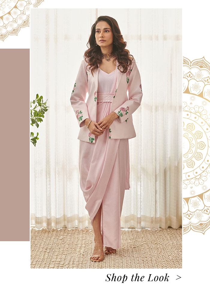 Model wearing a embroidered pink blazer and saree dress