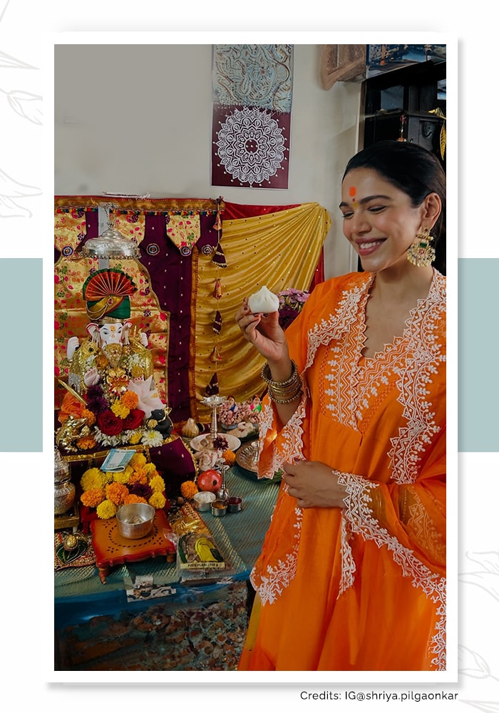 Shriya Pilgaonkar wearing a simple orange kurta and dupatta and smiling at Lord Ganesh ji