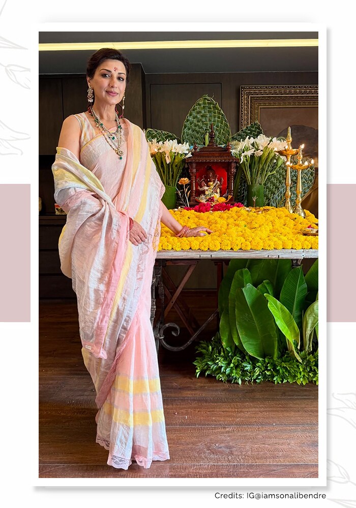 Sonali Bendre in a peach silk saree standing beside Ganesh