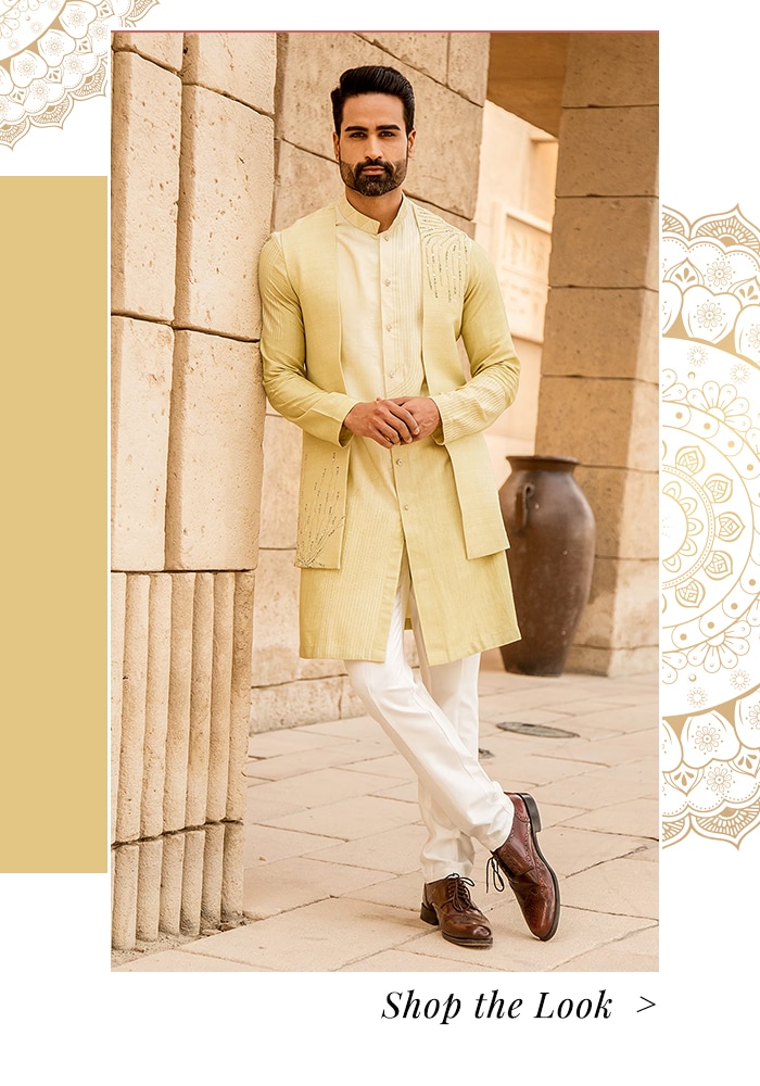 Model wearing yellow jacket and kurta set