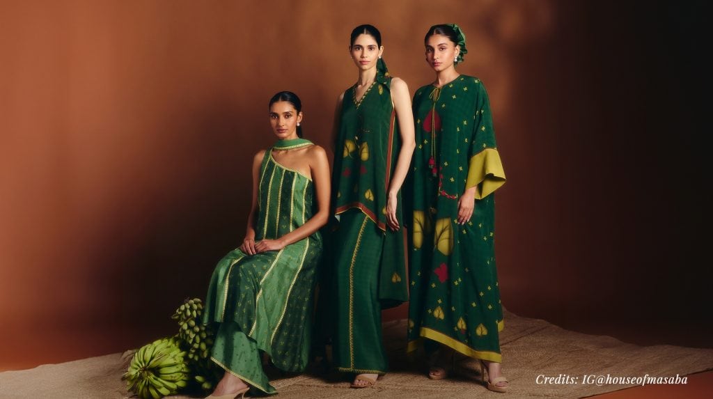 Three female models wearing green Indo-Western outfits.