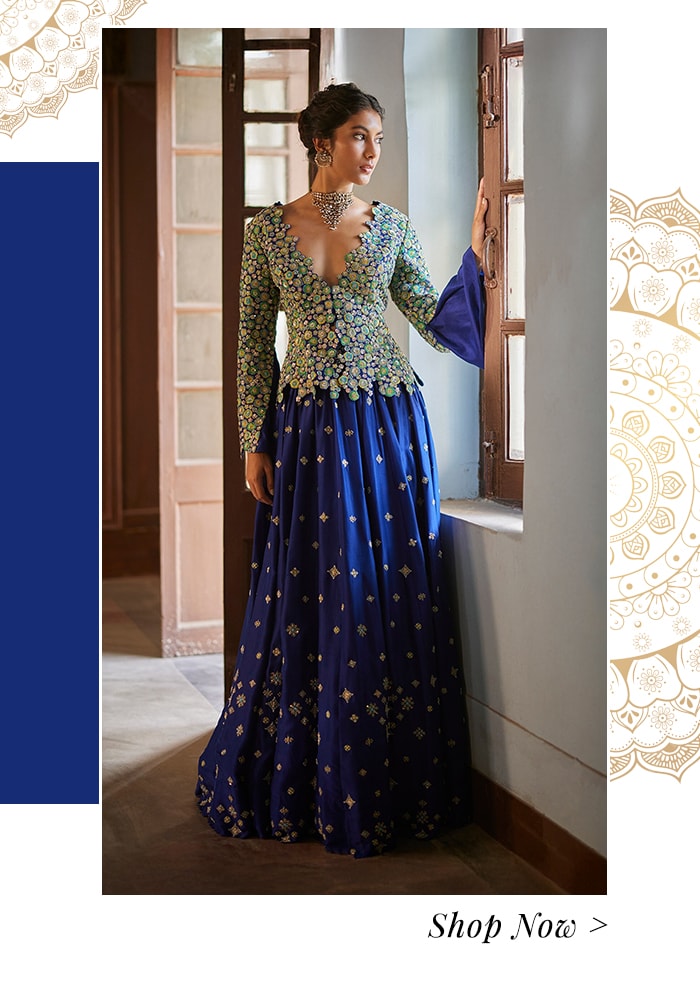 Model wearing a royal blue lehenga with a embroidered jacket