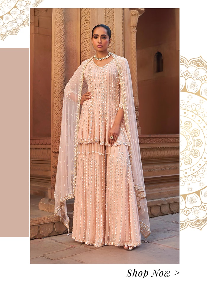 Model wearing a blush pink peplum kurta and sharara set