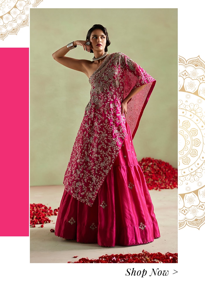 Model wearing a rani pink embroidered kaftan and lehenga set