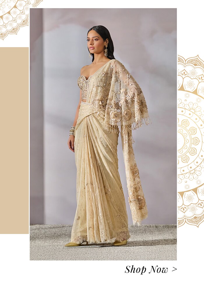 Model wearing an ivory cape jacket and saree set