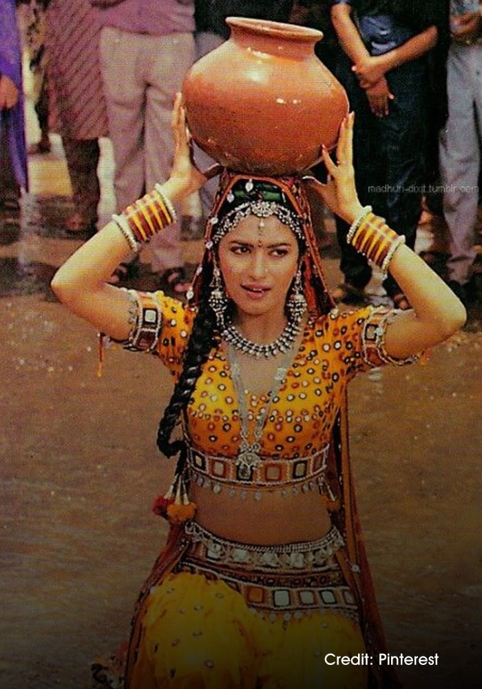Madhuri Dixit wearing a yellow lehenga choli on screen