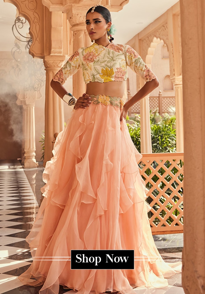 Model wearing a peach ruffle lehenga set