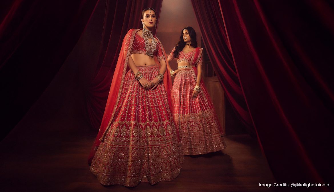 Two models wearing red lehengas