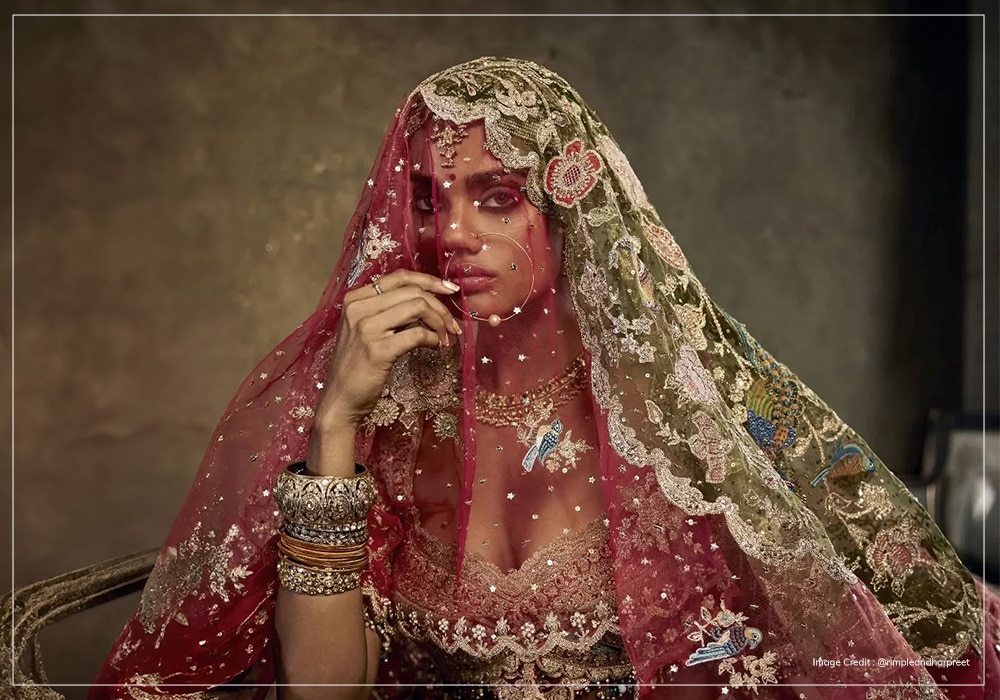 Model behind a red bridal veil