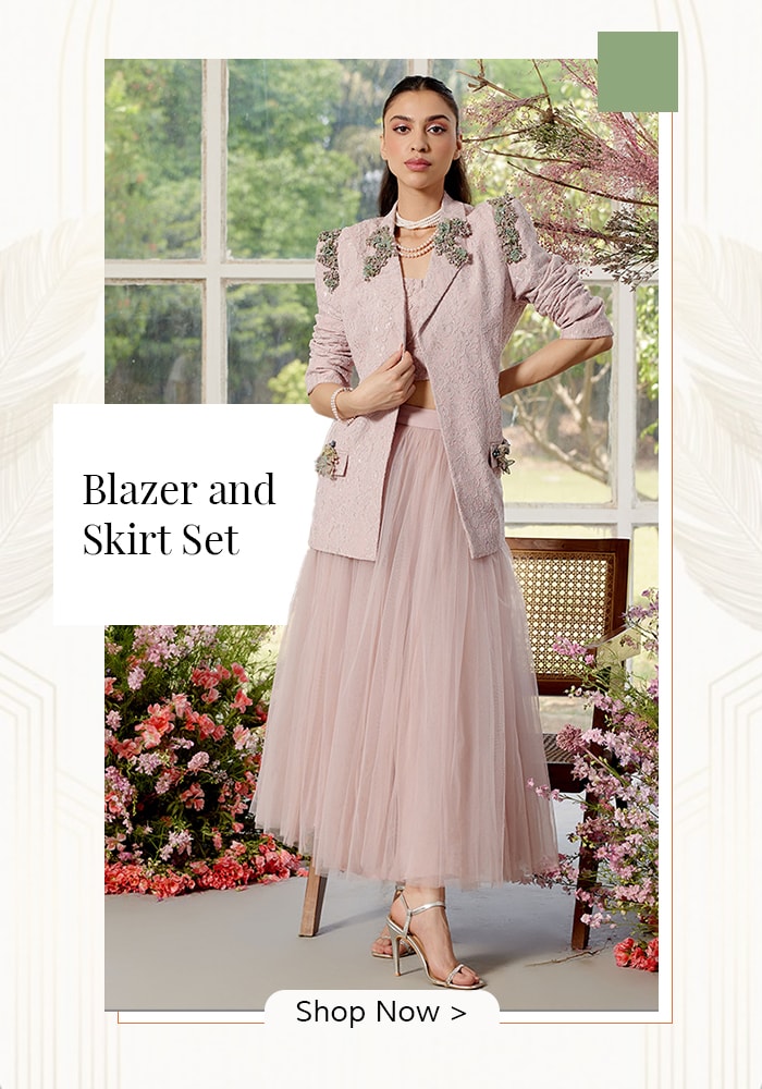 Model wearing blush pink blazer and skirt set