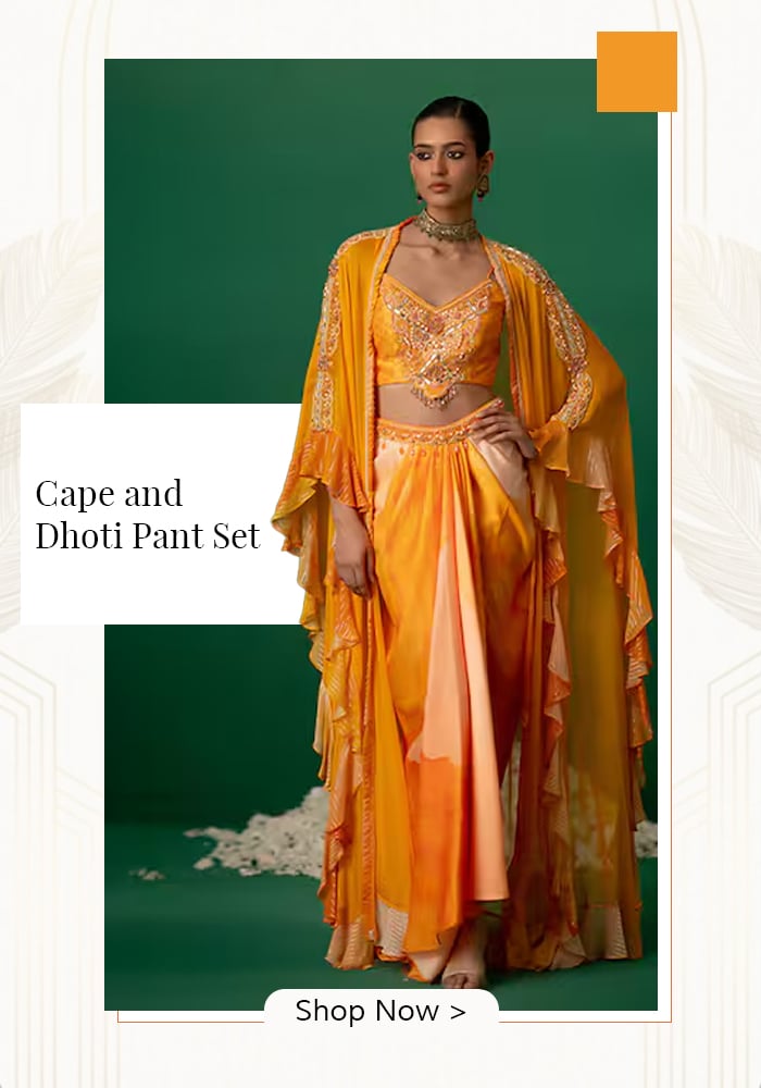 Model wearing orange printed cape and dhoti pant set