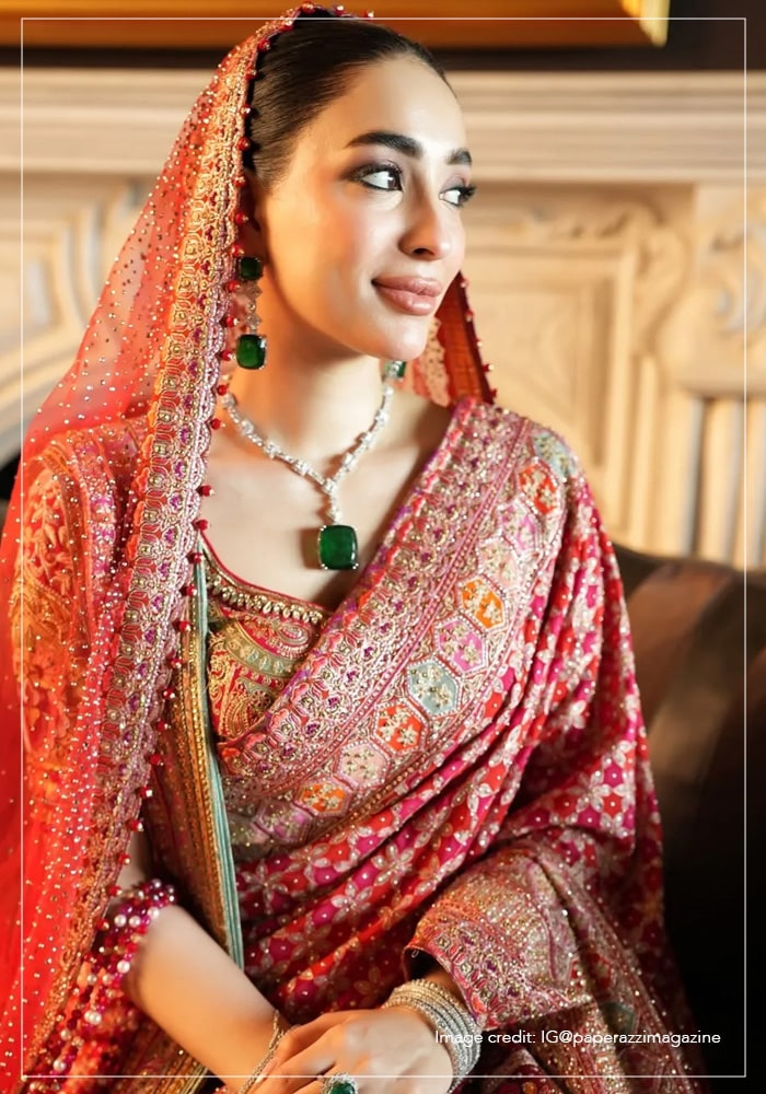 Shanzeh Ali wearing emerald green kundan jewellery set and red dupatta with red Tarun Tahiliani saree