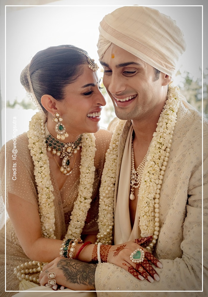 Prateik Babbar and Priya Banerjee wedding look wearing ivory attires and white flower garland