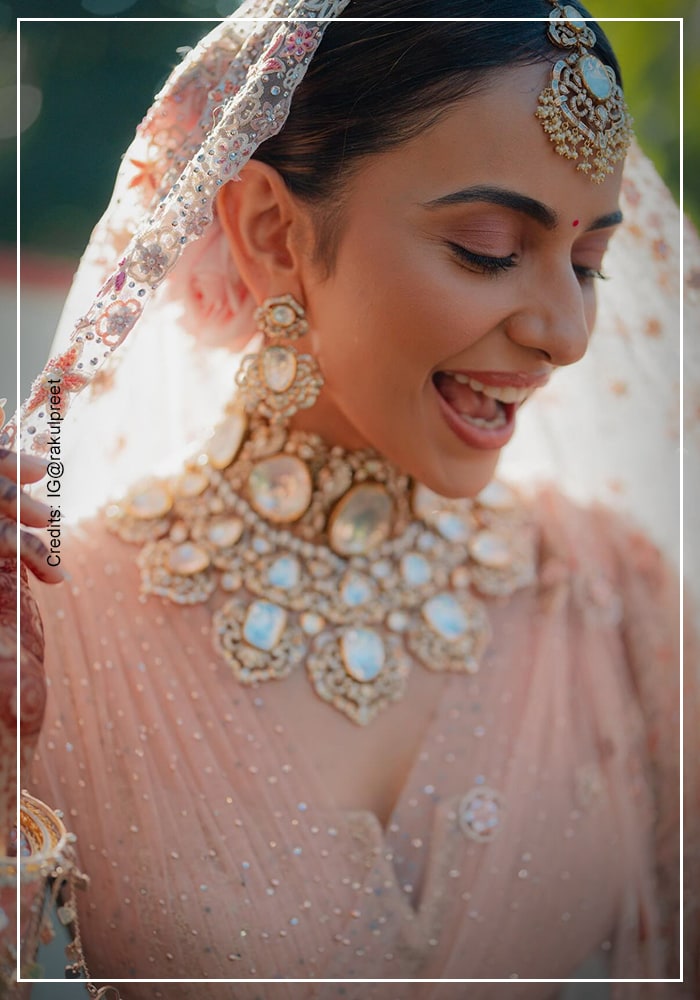 Rakul Preet Singh wearing kundan bridal jewellery and pink lehenga on her wedding day
