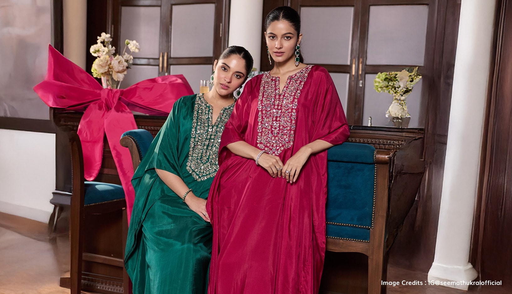 Two models wearing green and pink kaftans