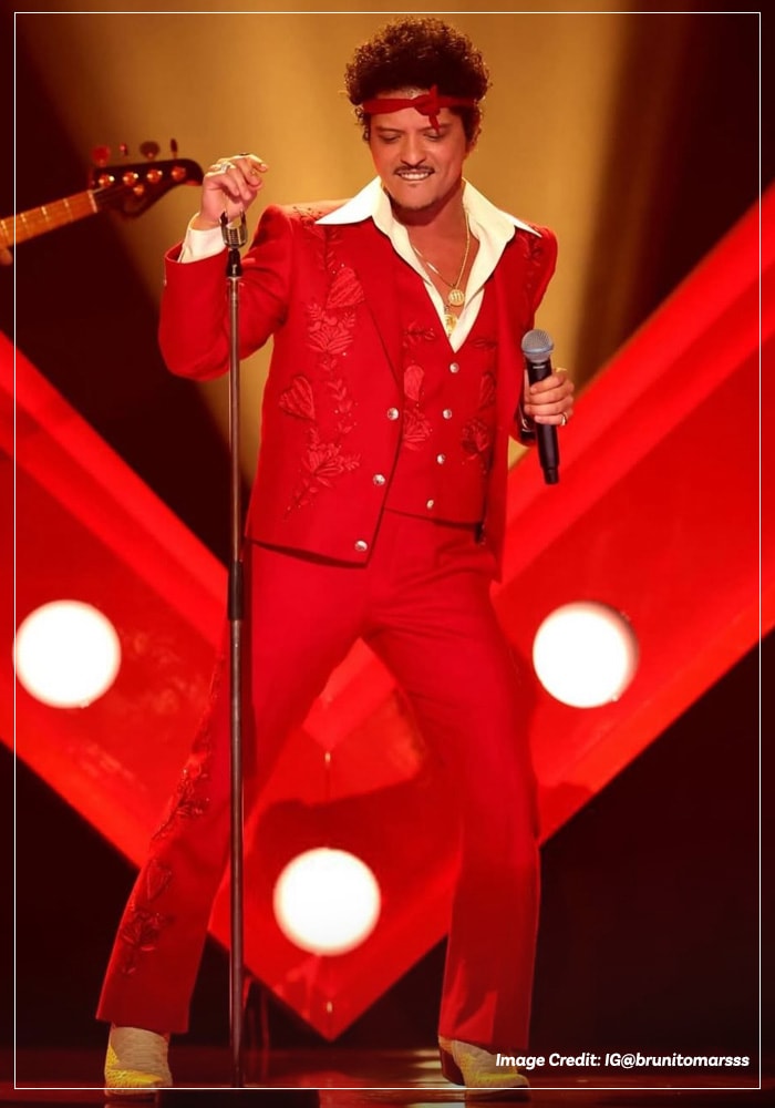 Bruno Mars performing solo in red three-piece suit at the Grammys 2026