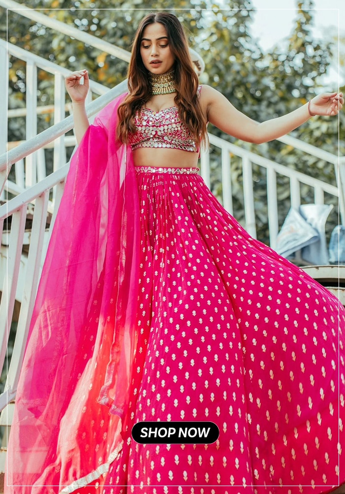 Woman posing in pink mirror embroidered lehenga choli with dupatta