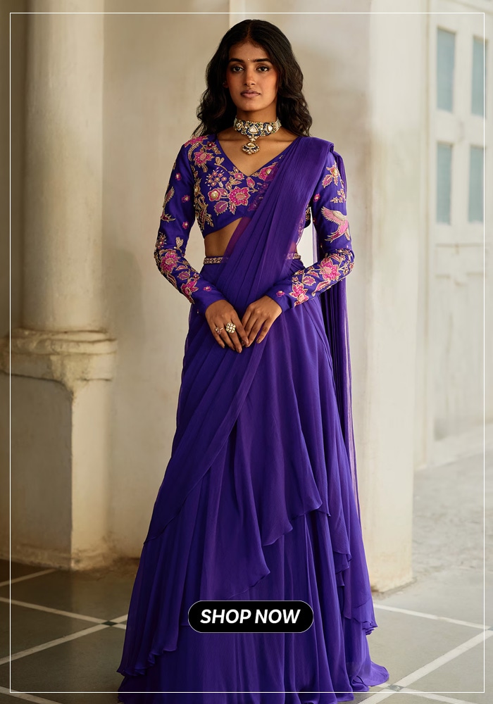 Woman posing in purple ruffle pre-draped saree with embroidered matching blouse