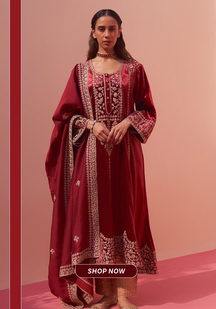 Deep maroon embroidered choga salwar suit with ornate detailing, styled as a wedding-ready festive ensemble
