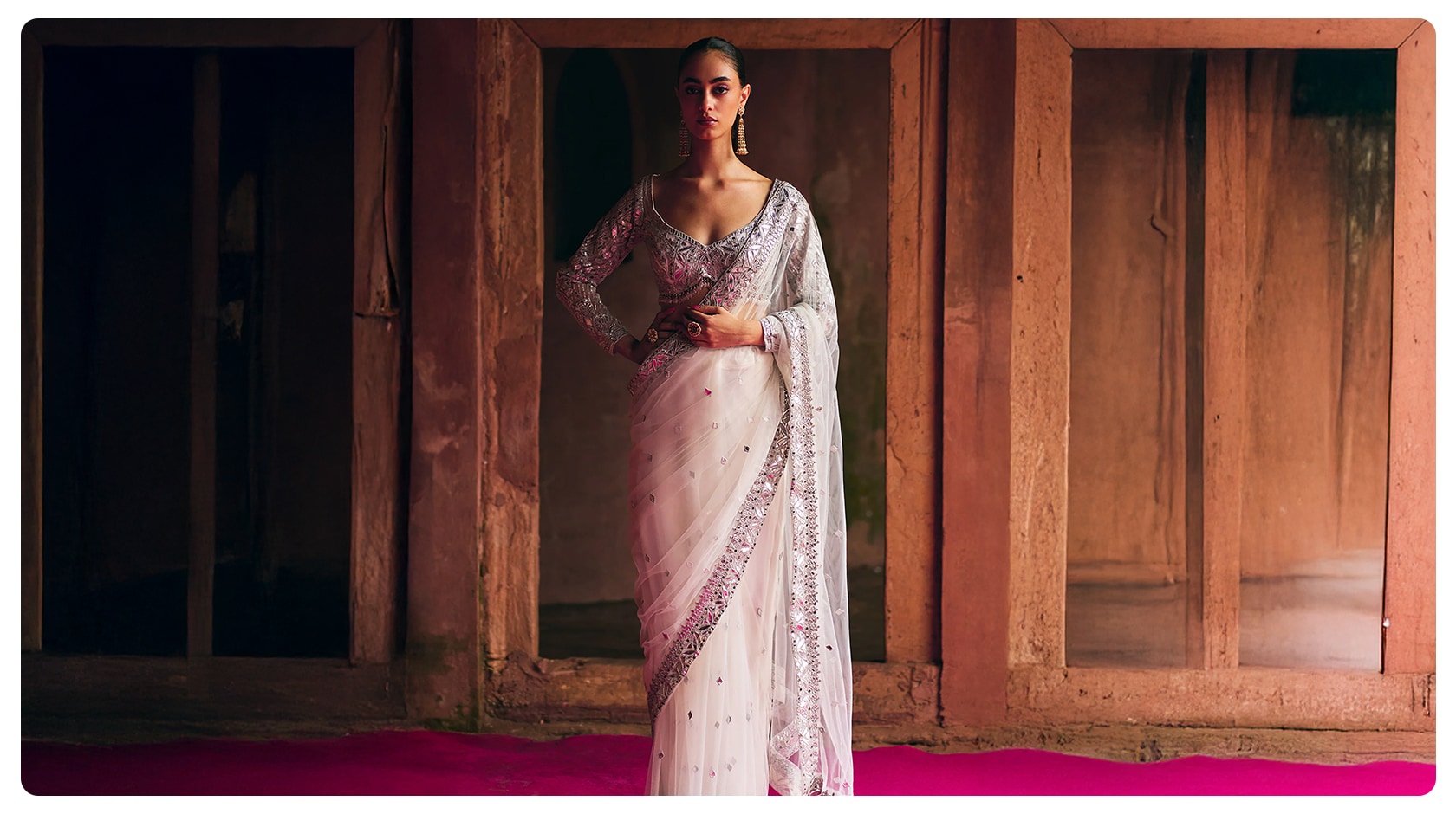 Model wearing a white embellished saree styled for Mahashivratri, reflecting minimal festive ethnic wear for women