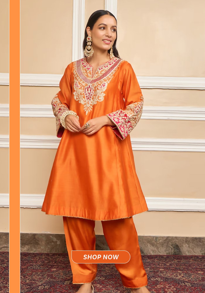 Orange embroidered choga salwar suit with traditional motifs, styled for festive gatherings and cultural celebrations