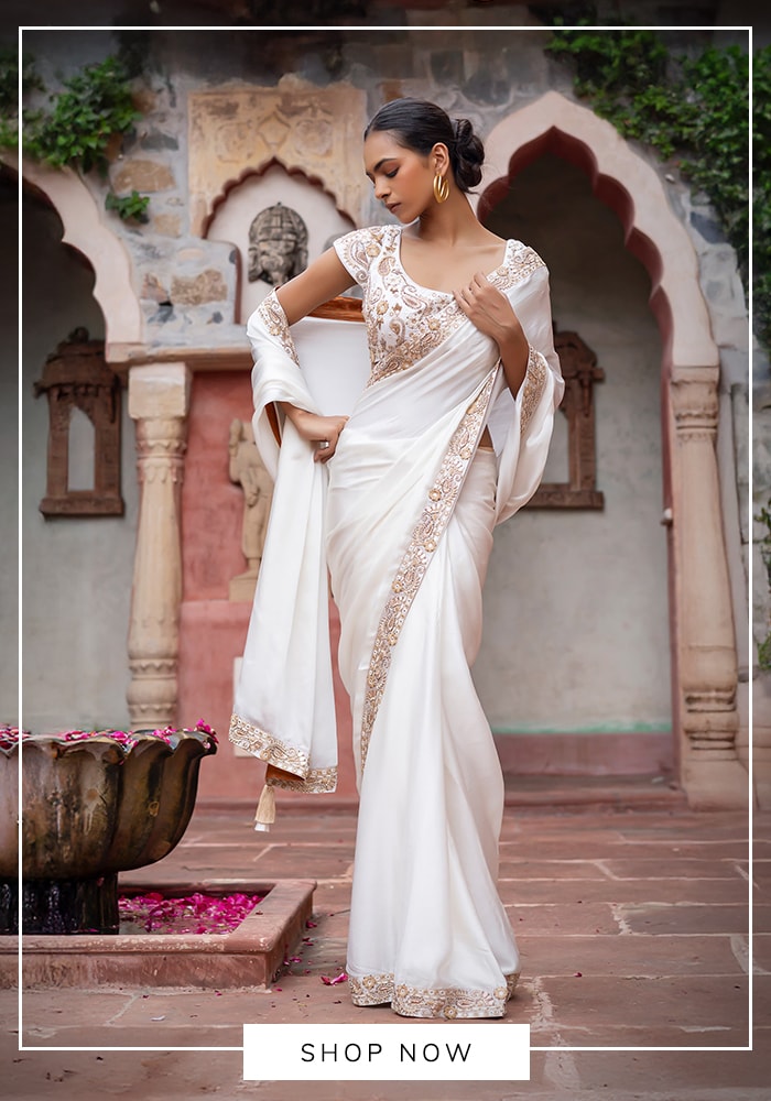 White embroidered saree with delicate border and soft drape