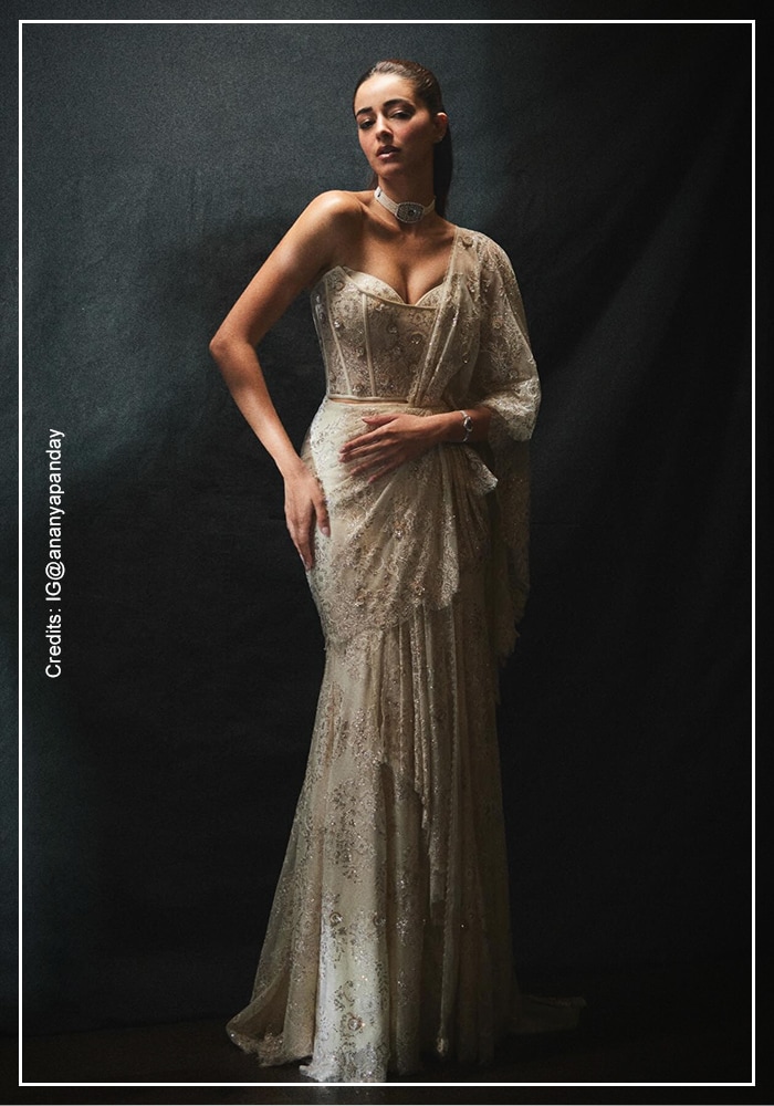 ull length view of Ananya Pandey in Tarun Tahiliani pre-draped concept sari featuring champagne lace, sequin embroidery, and mermaid silhouette with one-shoulder drape