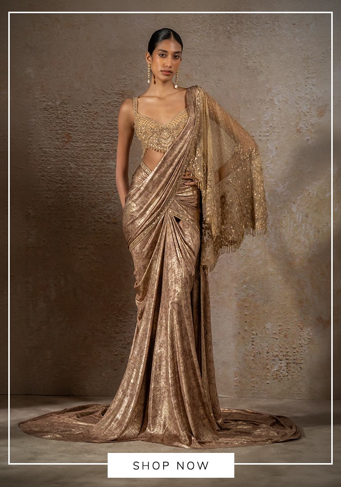 Tarun Tahiliani gold metallic concept sari with heavily embroidered bustier blouse and fringed sheer pallu — luxury Indian bridal and festive wear