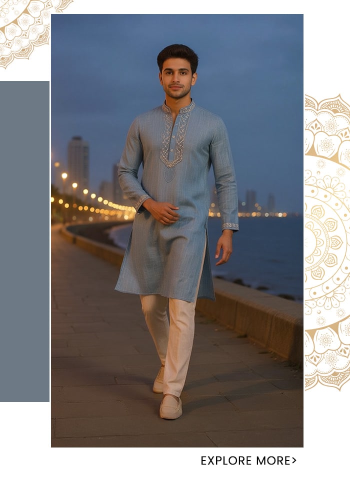 Sky blue schiffli embroidered linen kurta for men with delicate neckline and cuff detailing, styled with cream churidars walking along Marine Drive Mumbai at blue hour — Aza Fashions