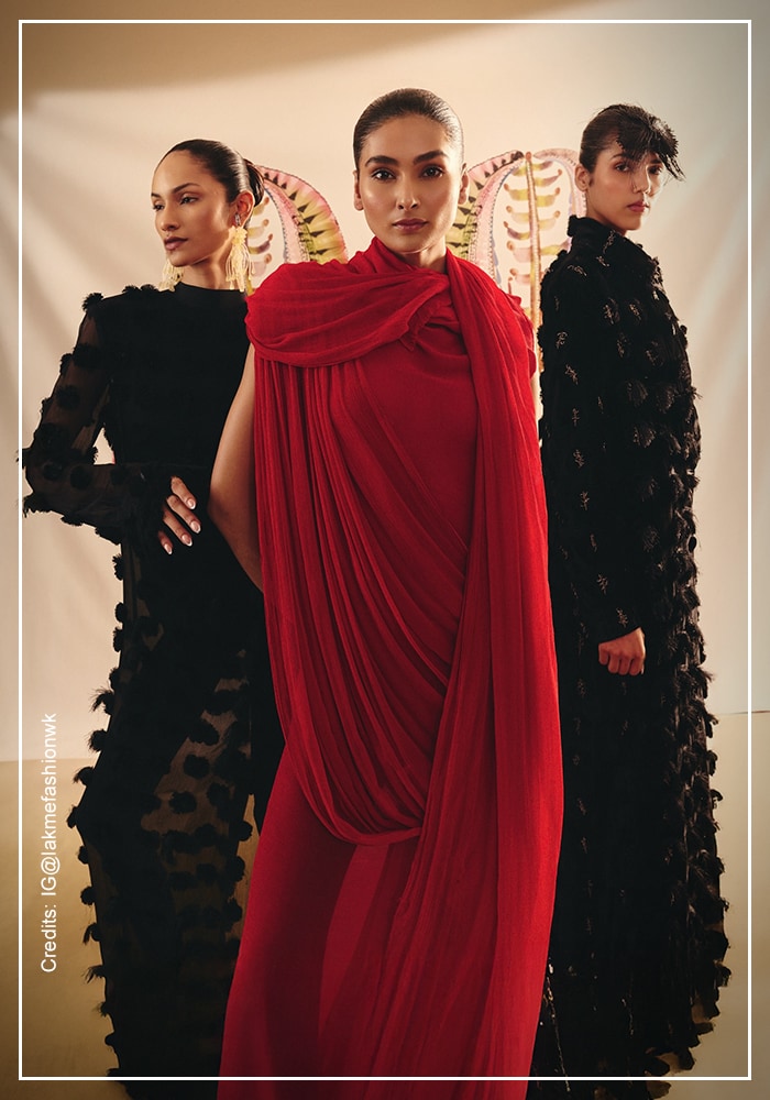 Red and black Anamika Khanna outfits display at Lakme Fashion Week