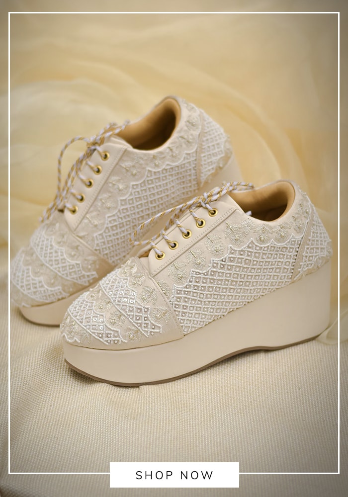 White sneakers paired with long flowy maxi dress for a sporty and comfy look