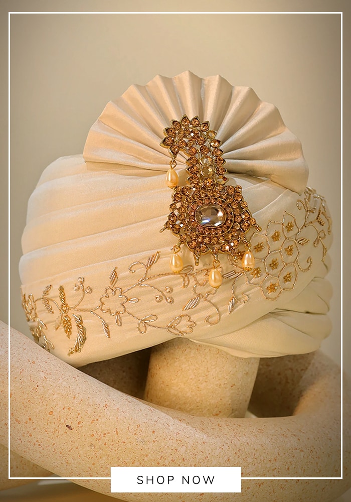 You can easily transform a standard bandhgala into complete traditional groomswear by adding the right cultural elements. A customized safa (turban) and an intricately woven stole instantly elevate the outfit to royal status.  Styling Tips: Choose a contrasting pastel safa if your bandhgala is a dark, solid color. Drape a Banarasi silk stole over one shoulder and secure it with a subtle pin. Add layered pearl or emerald malas (necklaces) and classic embellished jutties to complete the regal transformation. 
Perfect For: The main wedding ceremony. 