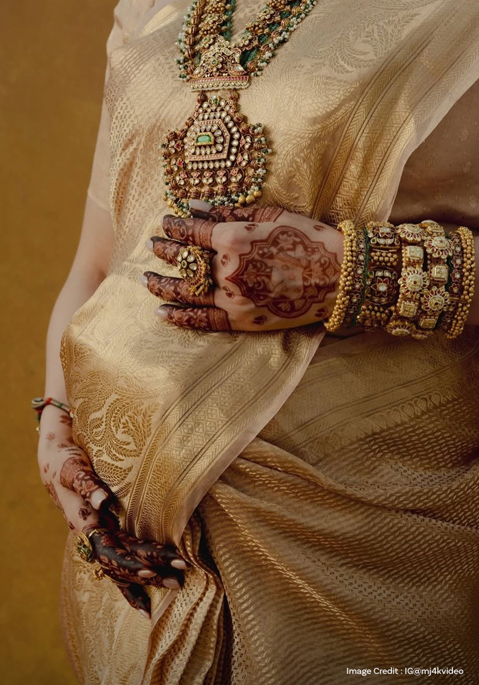 Karisma Tanna wearing gold stakced bangles on her Godh Bharai look