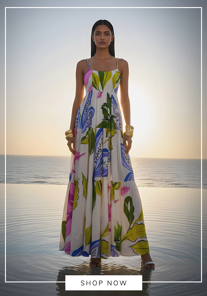 Woman wearing a white abstract print maxi dress with colorful botanical motifs, perfect for elegant Mahjong parties and summer gatherings