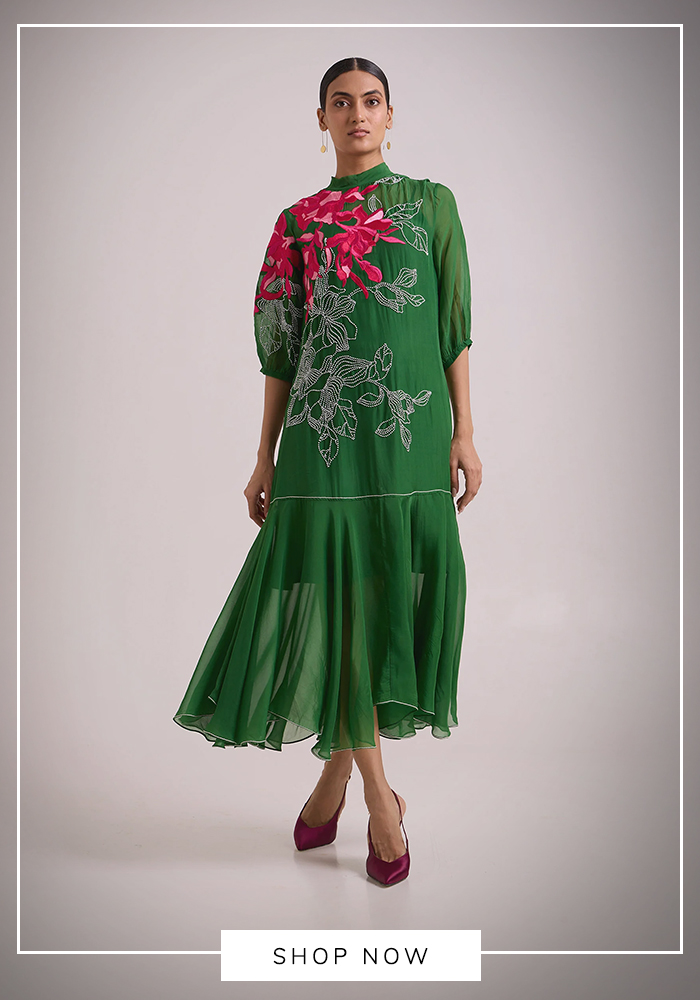 Woman wearing a multicolour botanical print halter maxi dress with an asymmetrical silhouette, perfect for a chic Mahjong party or luxury daytime gathering