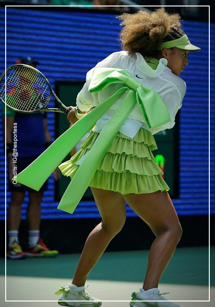 Naomi Osaka in lime green dress and bomber jacket