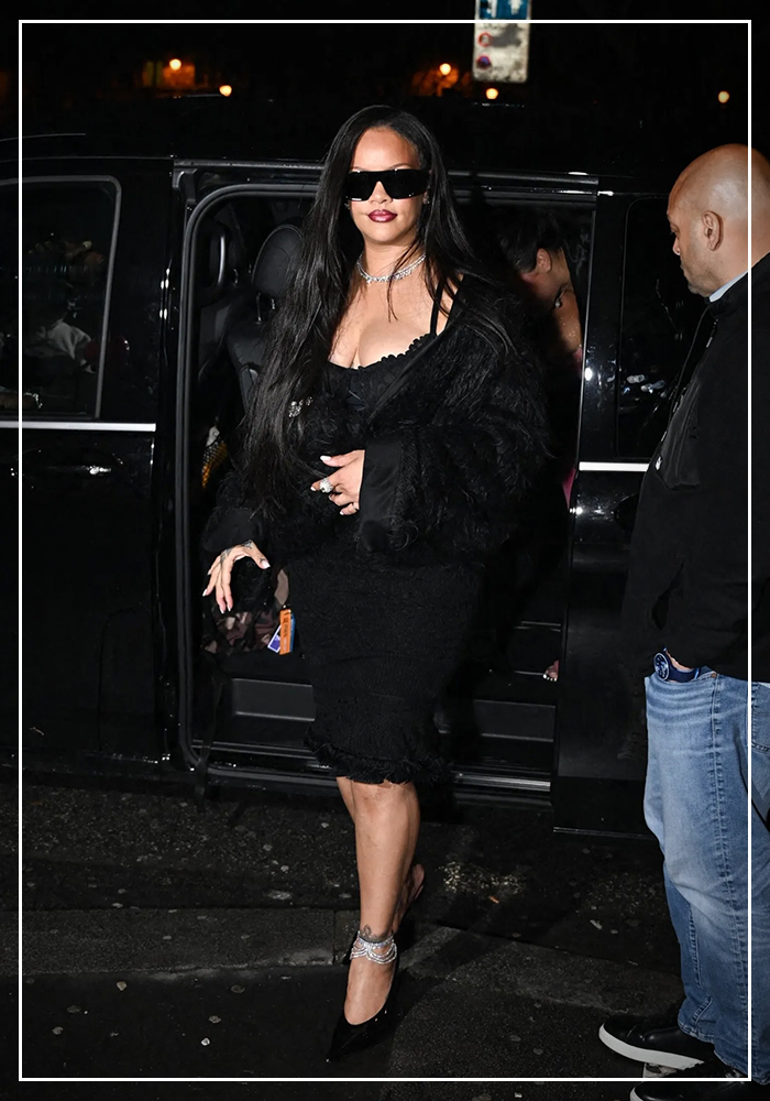 Rihanna wearing anklet with her black midi dress
