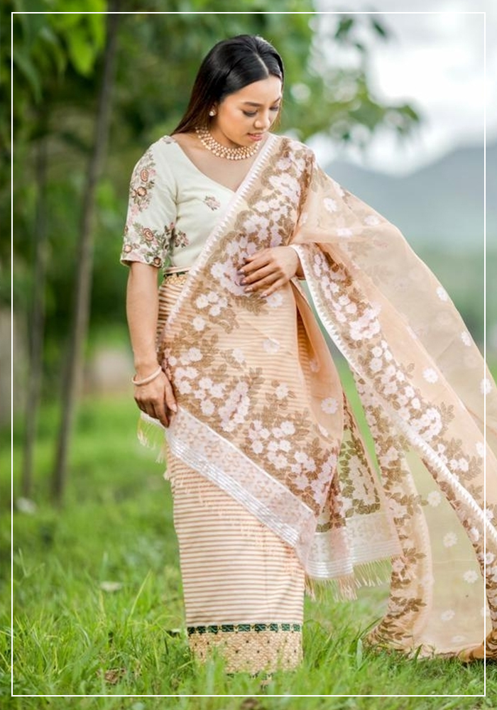 Saikhom Mirabai Chanu wearing Phanek and Inaphi Mizoram's traditiona dress