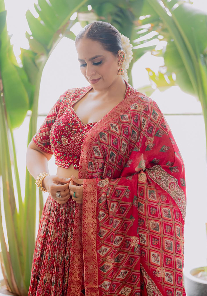 Abhinisha Jani Ashara in maroon Samyukta Singhania with draped dupatta