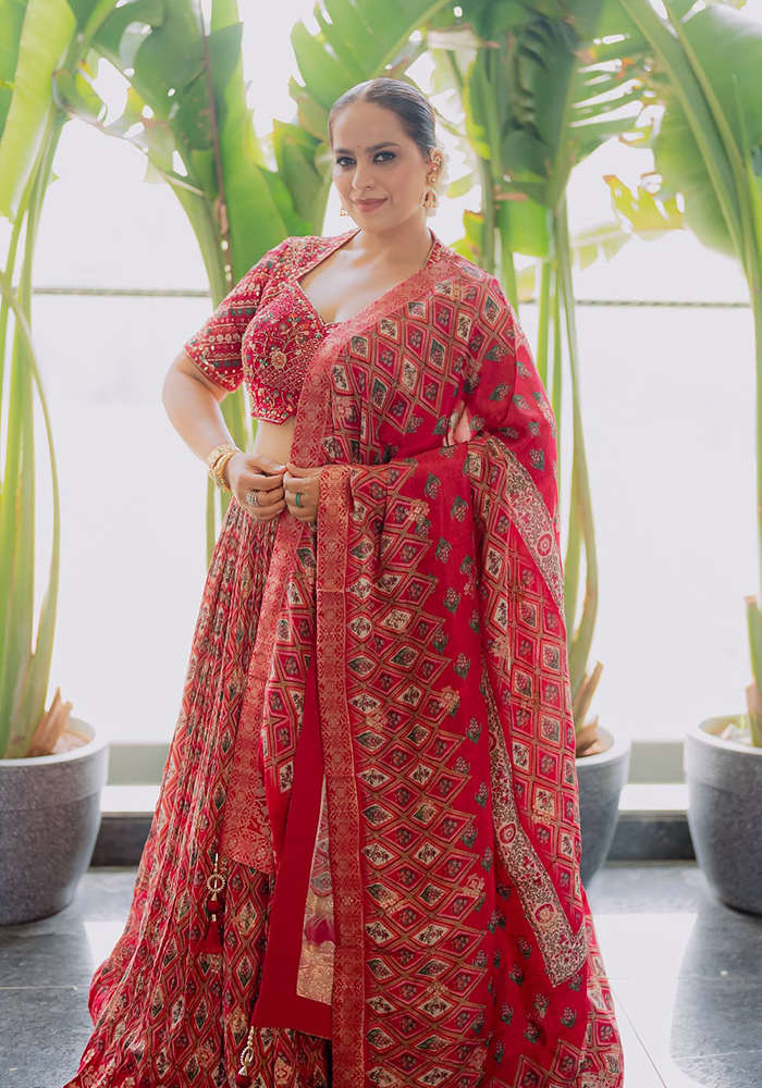 Abhinisha Jani Ashara in maroon Samyukta Singhnia lehenga
