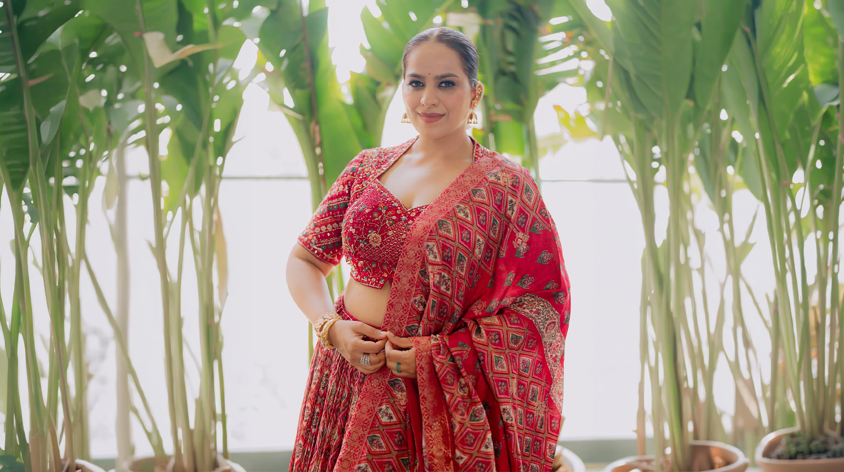 Influencer Abhinisha Jani Ashara wearing maroon Samyukta Singhania lehenga from Aza Fashions