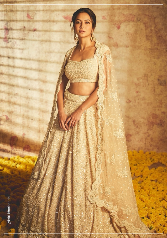 KritI Kharbanda in ivory and pear embroidered lehenga